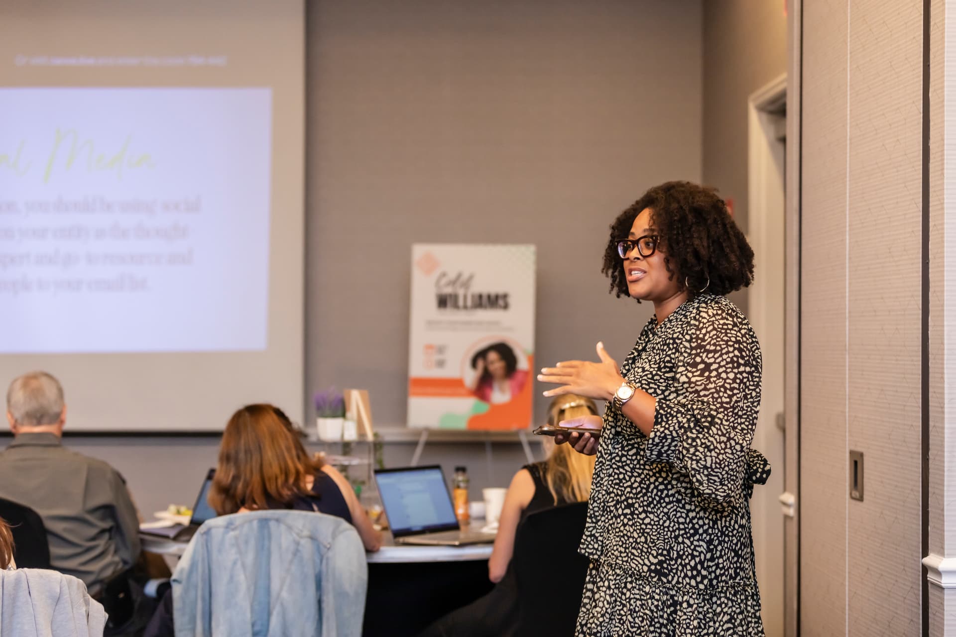Colet Williams leading a workshop session in front of a room of attendees