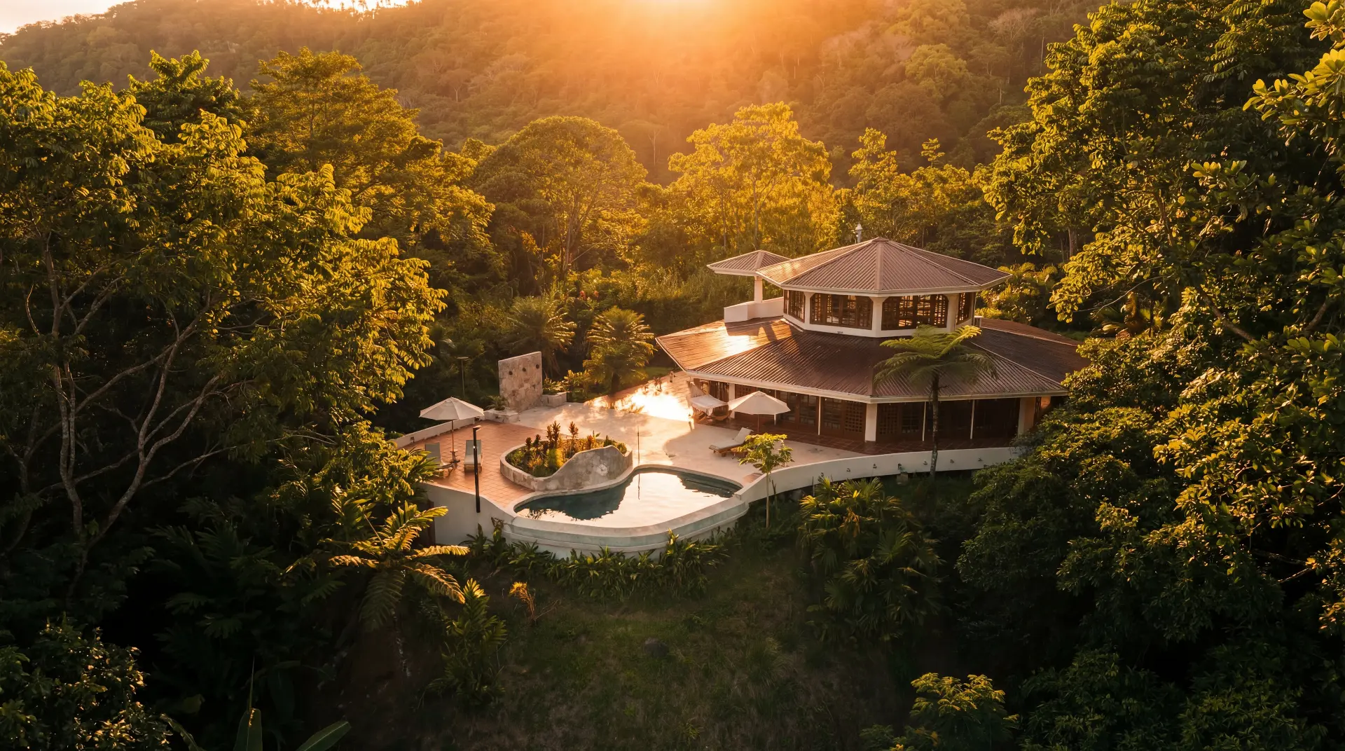 Imiloa villa nestled in the tropical jungle at sunset, with an infinity pool overlooking the rainforest canopy